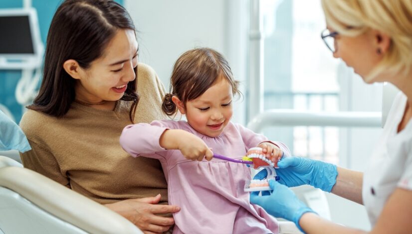young child at dental office with parent at pediatric dentist with hospital privileges