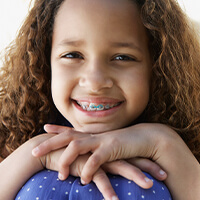 ortho-metal-braces smiling girl with braces